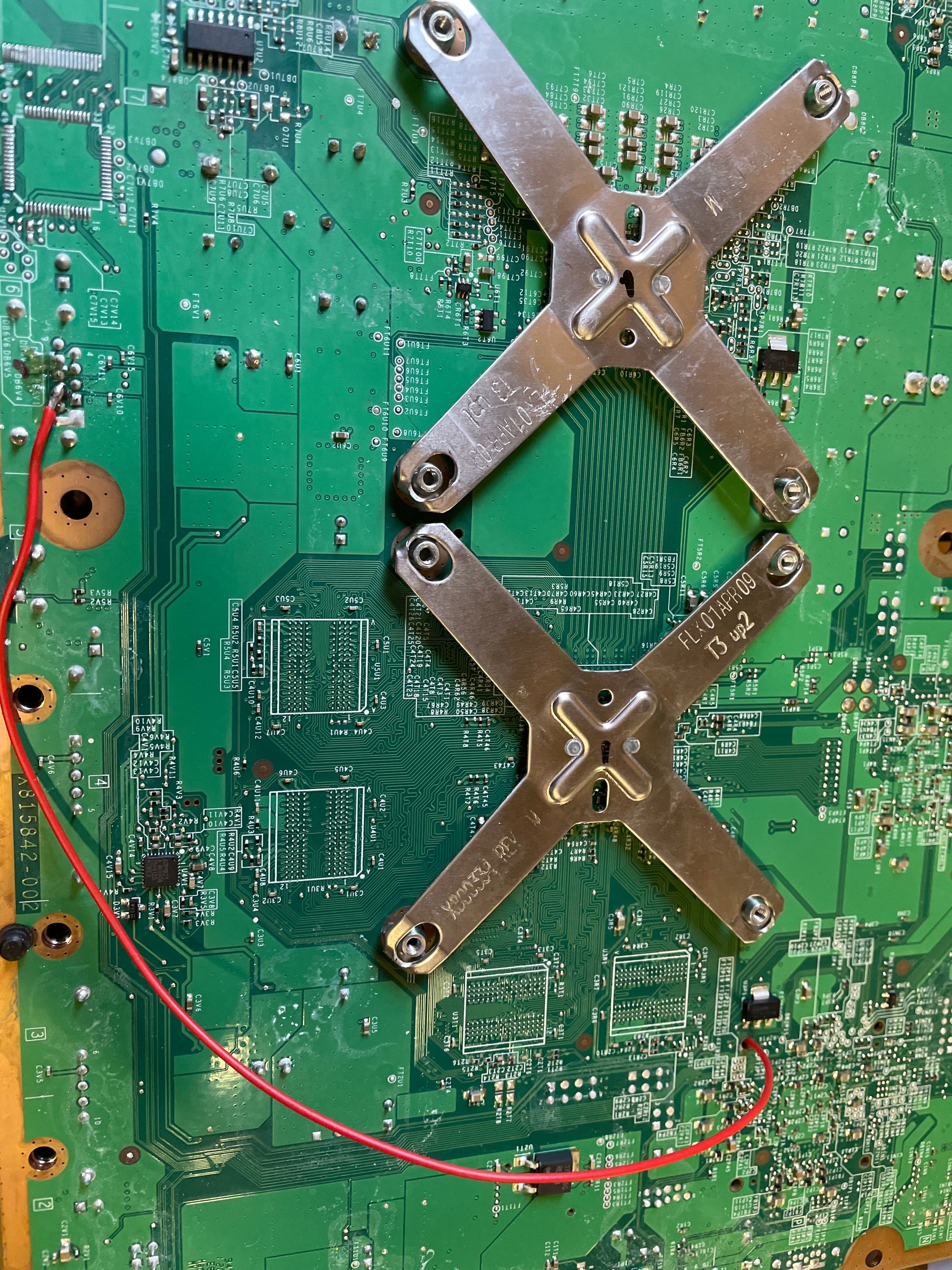 A image depicting a wire on the underside of a motherboard